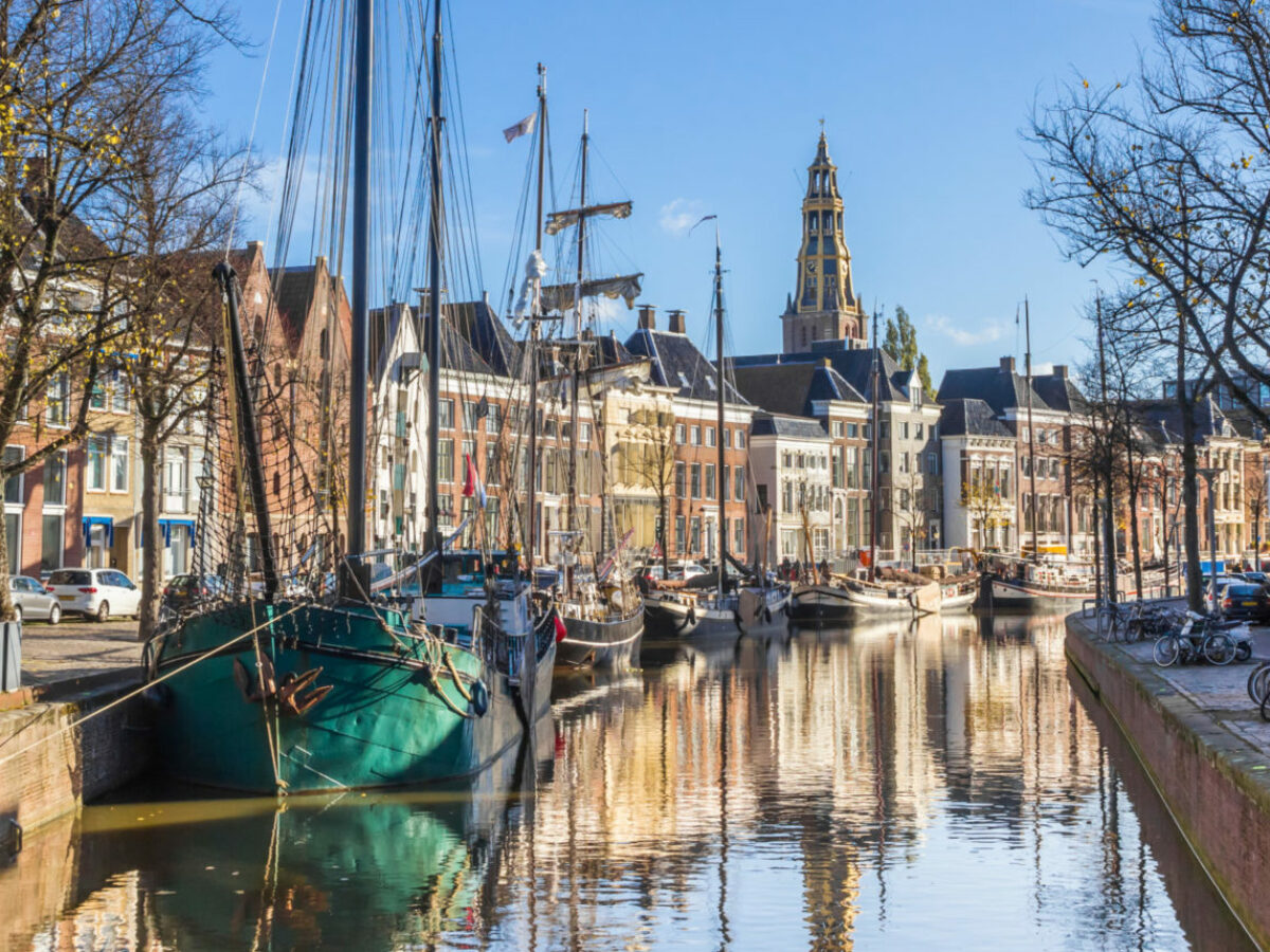 Panorama of historic ships and warehouses in the center of Groningen, Netherlands